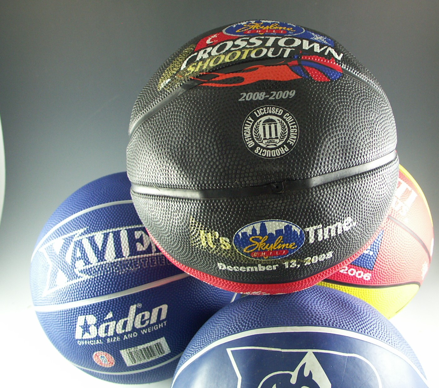 Four Collegiate Basketballs