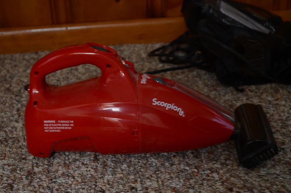 Bissell Vacuum Cleaner and a Handheld Dirt Devil 