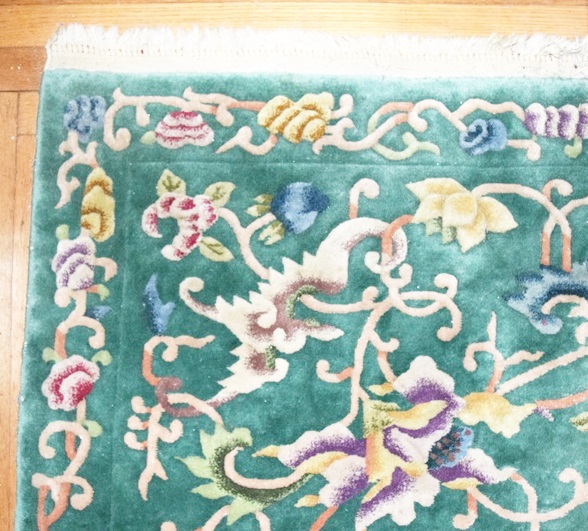 A Room Size All Wool Rug in Green with an Allover Floral Design 
