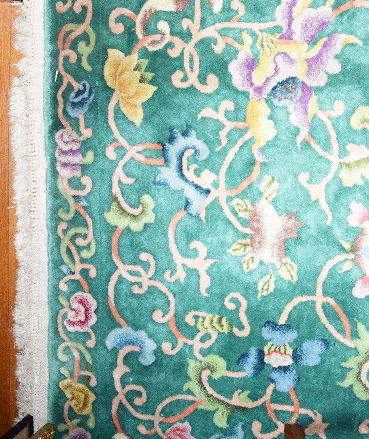 A Room Size All Wool Rug in Green with an Allover Floral Design 