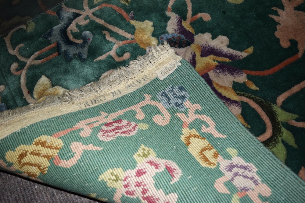 A Room Size All Wool Rug in Green with an Allover Floral Design 
