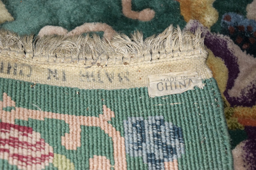 A Room Size All Wool Rug in Green with an Allover Floral Design 