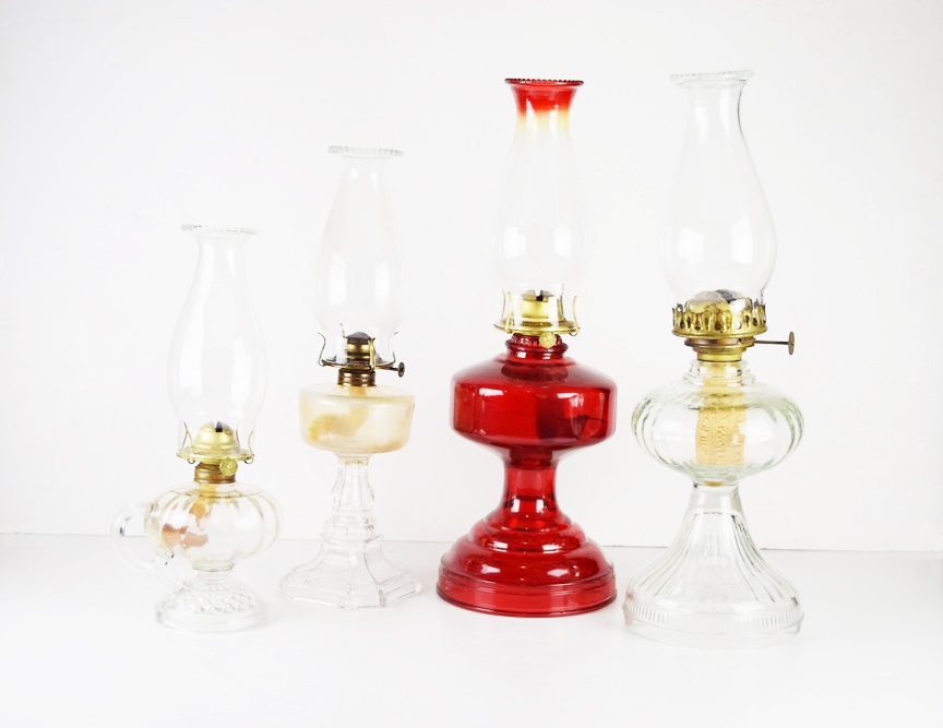 Four Antique Oil Lamps in a Variety of Sizes