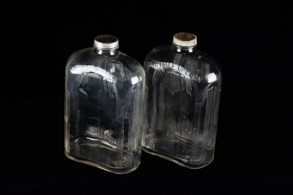 A Pair of Vintage Glass Half Gallon Milk Jugs