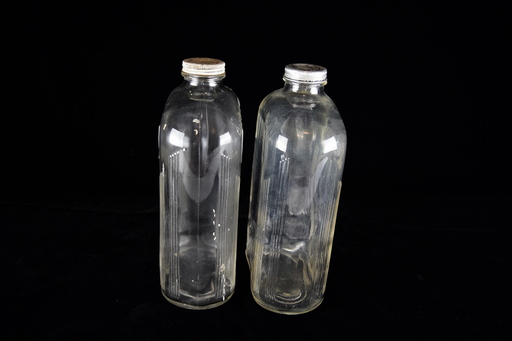 A Pair of Vintage Glass Half Gallon Milk Jugs