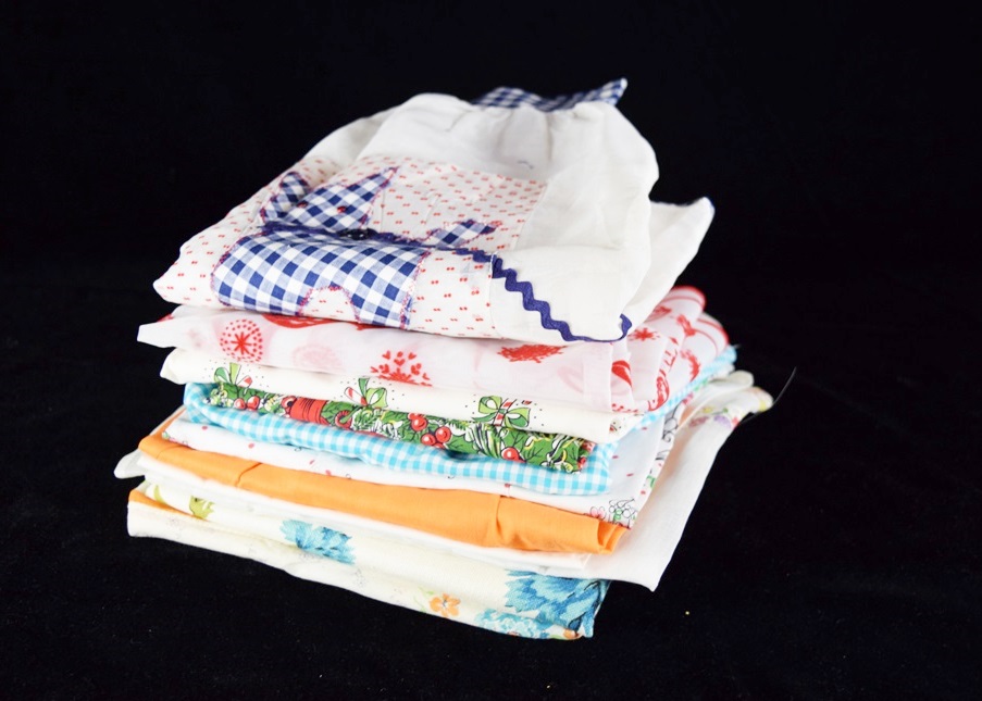 Eleven Vintage Aprons in a Variety of Prints