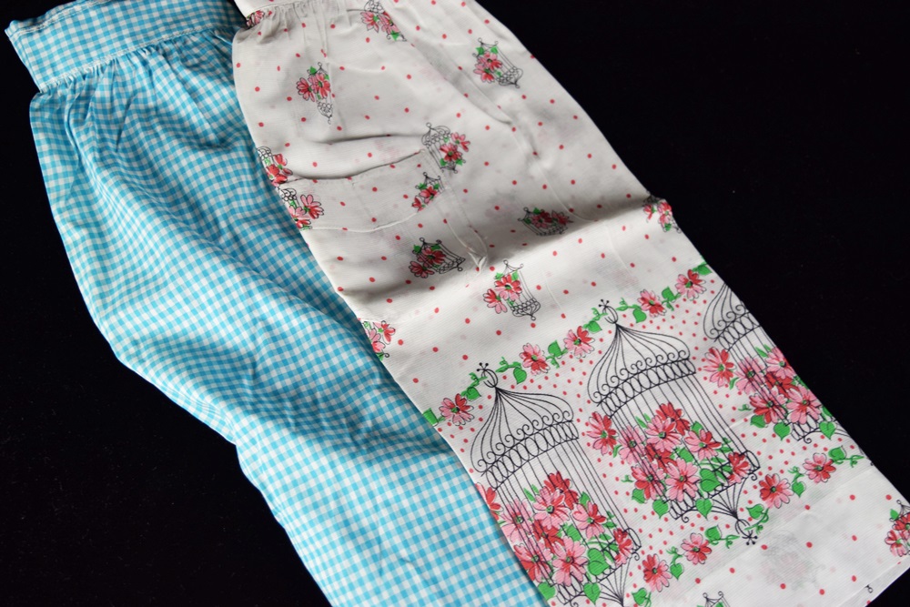 Eleven Vintage Aprons in a Variety of Prints