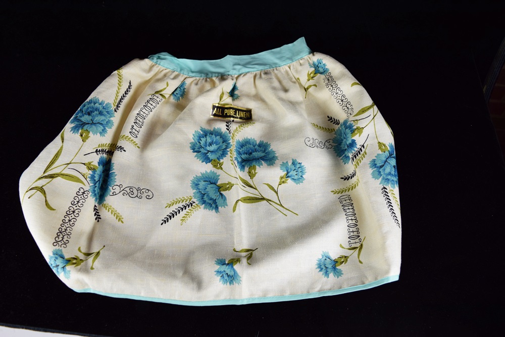 Eleven Vintage Aprons in a Variety of Prints