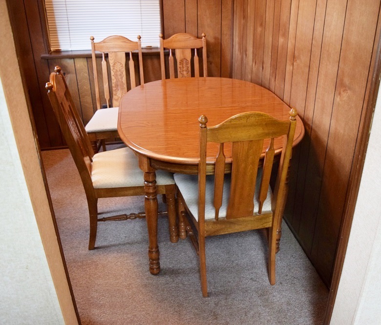 An Expandable Kitchen Table and Four Oak Chairs 