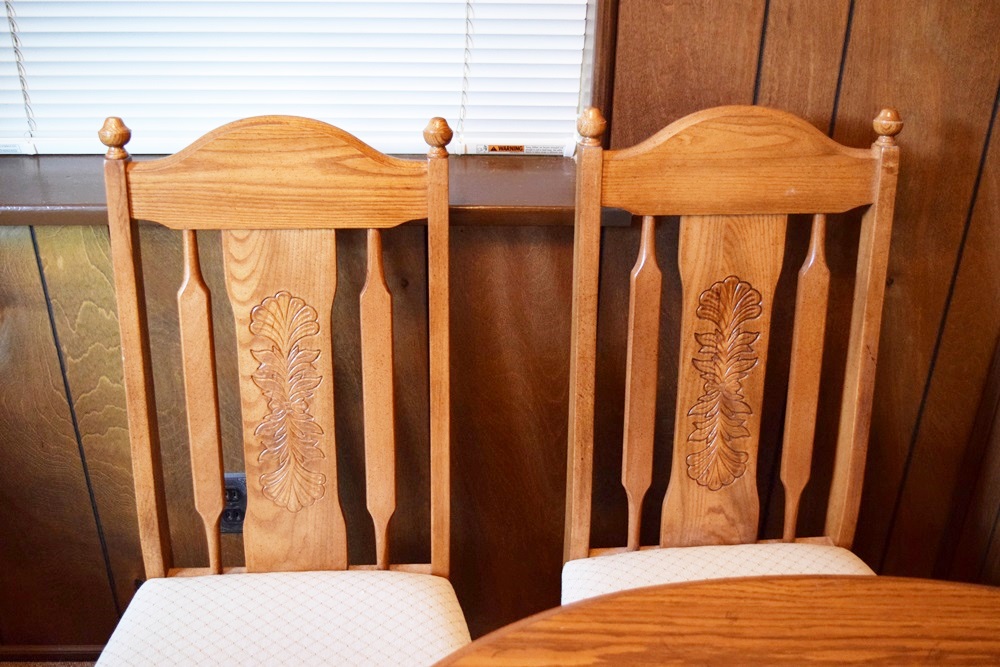 An Expandable Kitchen Table and Four Oak Chairs 