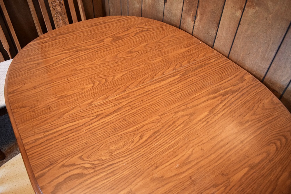 An Expandable Kitchen Table and Four Oak Chairs 