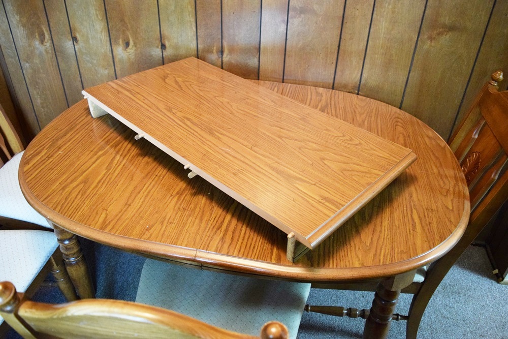 An Expandable Kitchen Table and Four Oak Chairs 