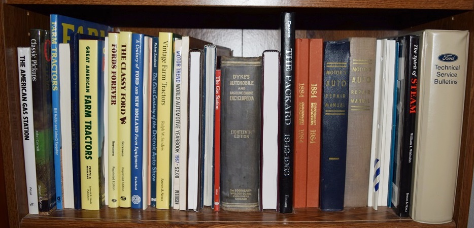 A Bookcase Filled with Books Referring to Cars and Trucks