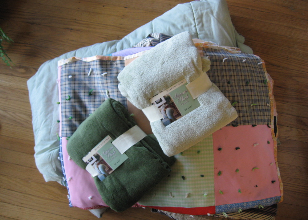 Collection of Multi-Colored Quilts and Blankets