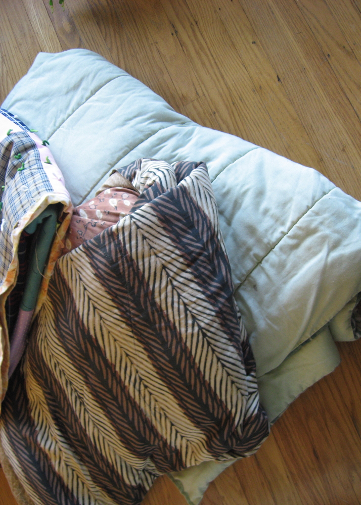 Collection of Multi-Colored Quilts and Blankets