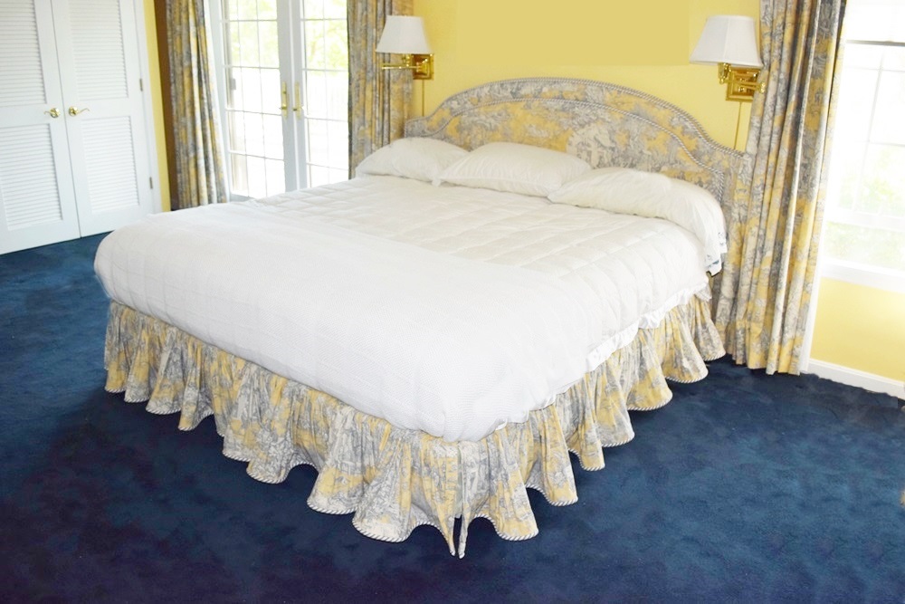 A King Size Bed with a Pretty Toile Upholstered Headboard