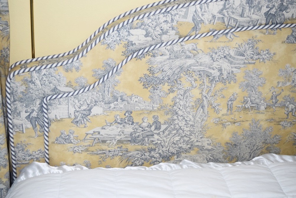 A King Size Bed with a Pretty Toile Upholstered Headboard