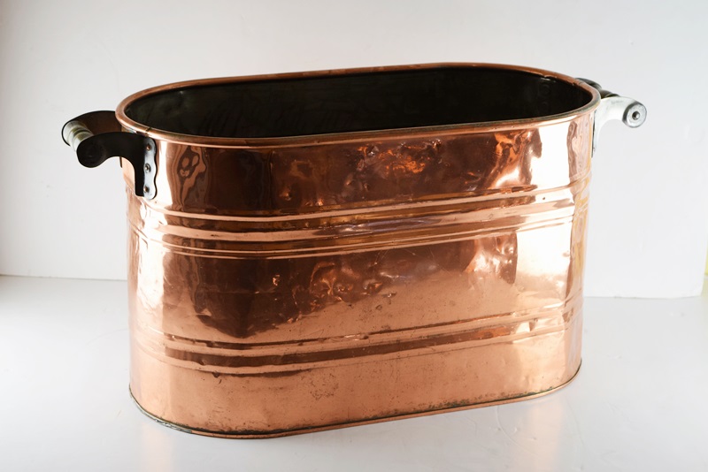 A Vintage Oval Copper Firewood Bucket with Wooden Handles