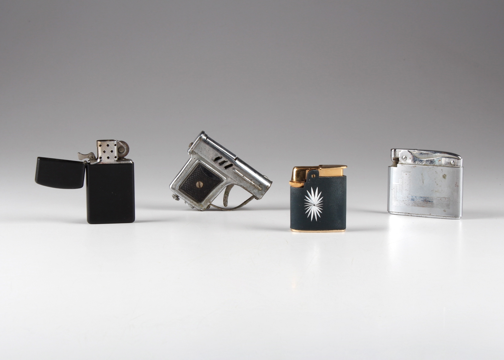 A Group of Four Vintage Lighters