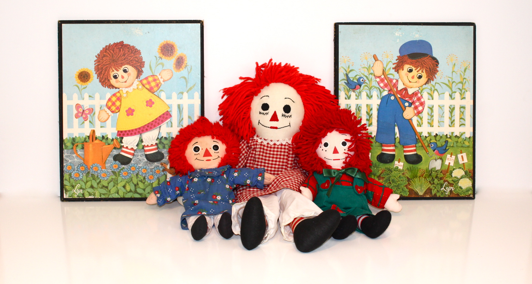 Vintage Collection of Raggedy Ann and Andy Dolls and Two Prints