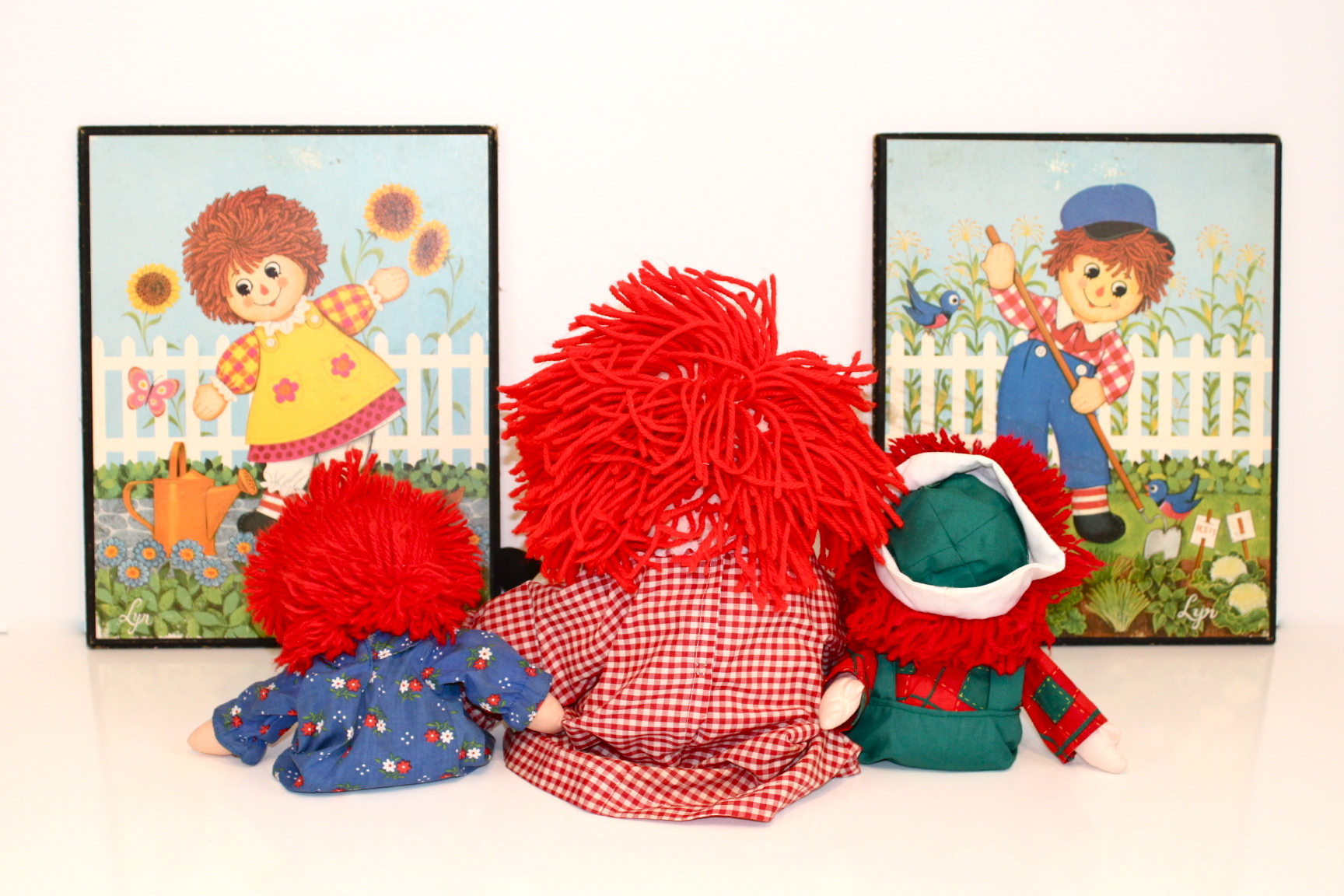 Vintage Collection of Raggedy Ann and Andy Dolls and Two Prints