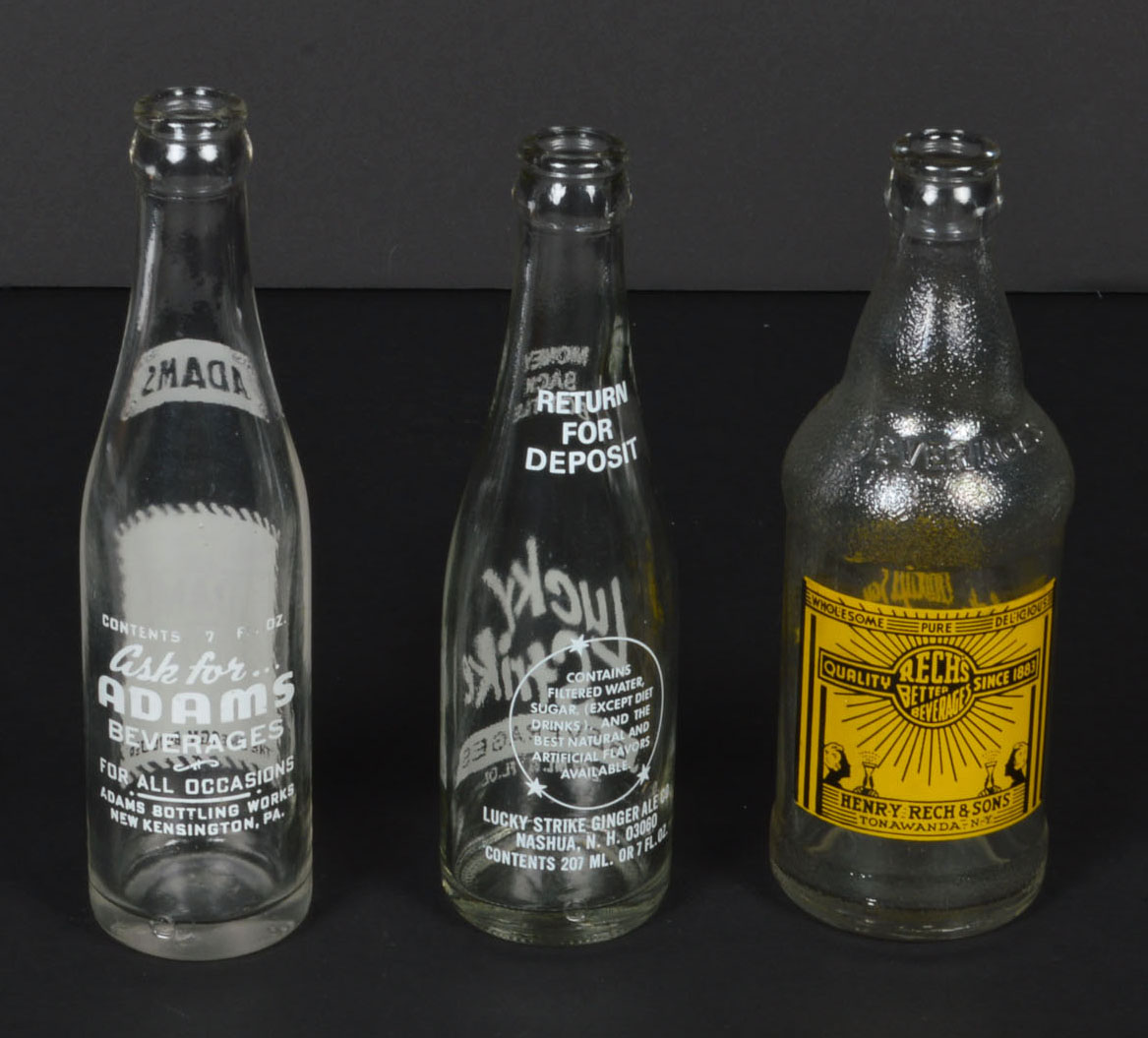 Collection of Vintage Soda Bottles and Ephemera