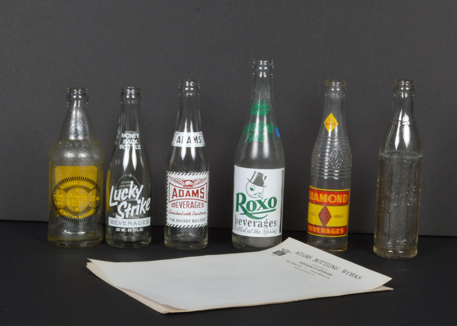 Collection of Vintage Soda Bottles and Ephemera
