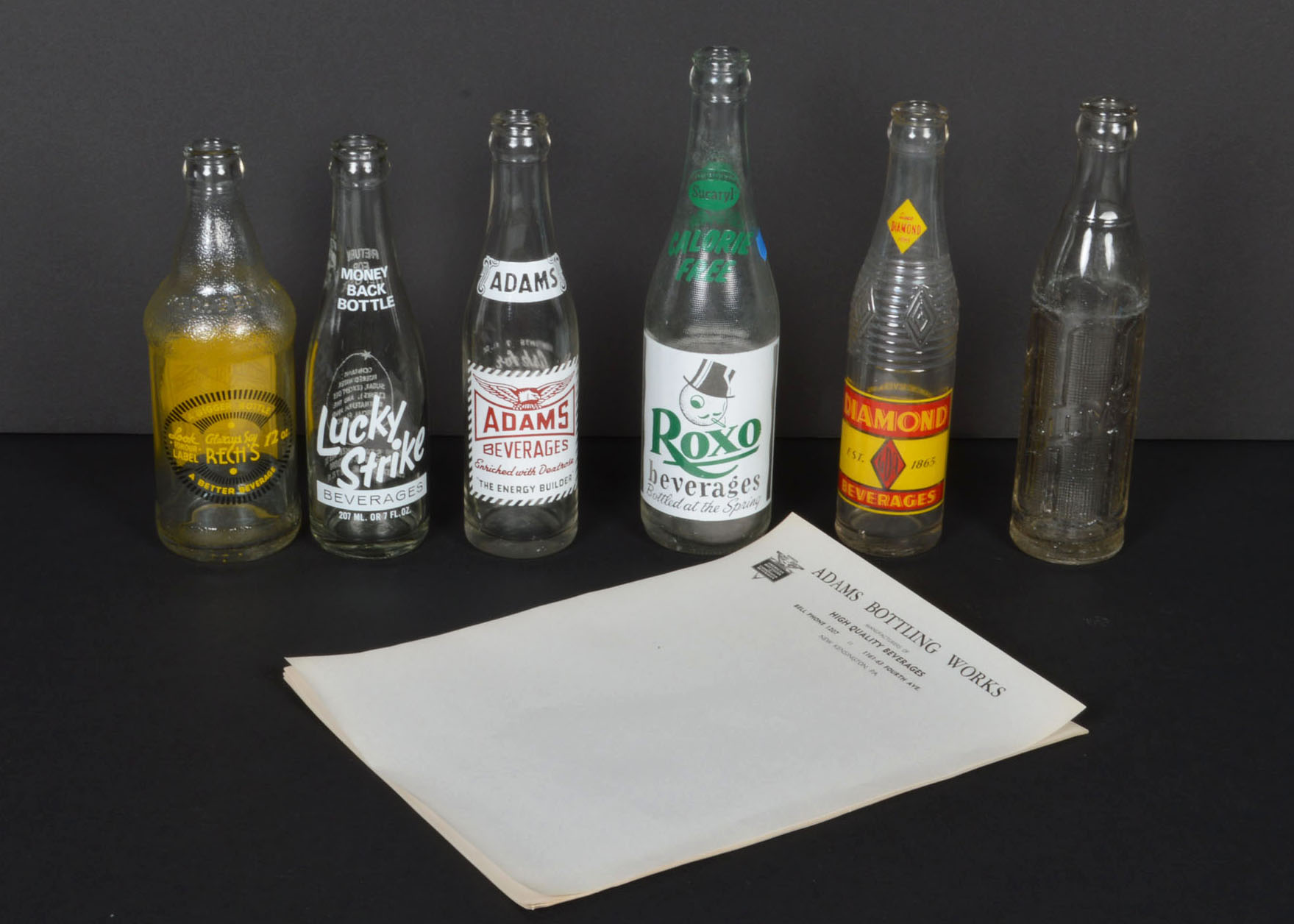 Collection of Vintage Soda Bottles and Ephemera