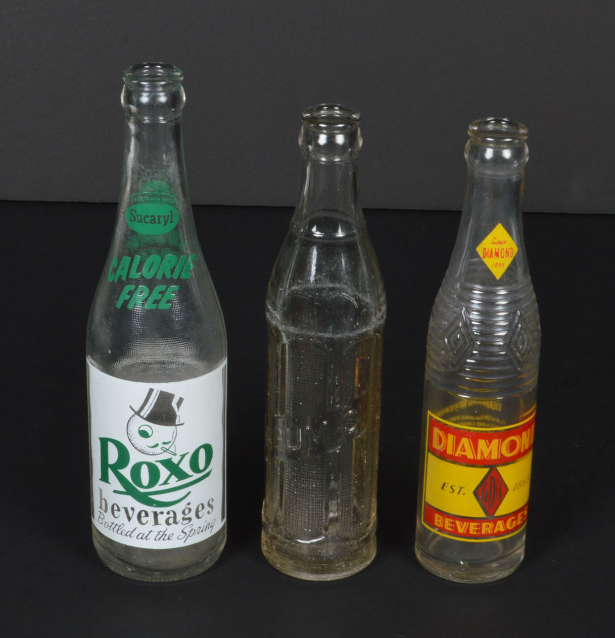 Collection of Vintage Soda Bottles and Ephemera