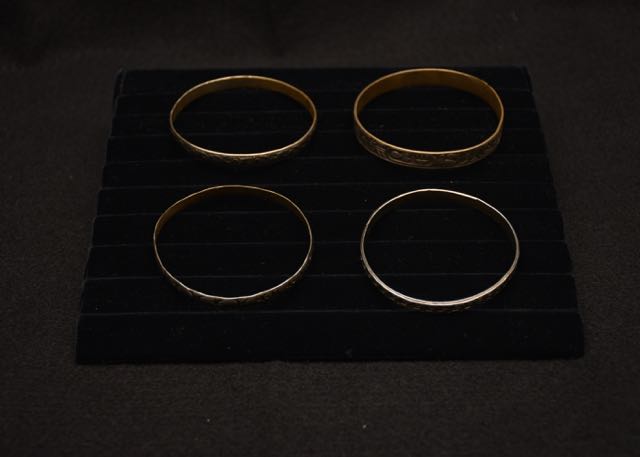 Four Ornate Bracelets Including one With an Egyptian Motif