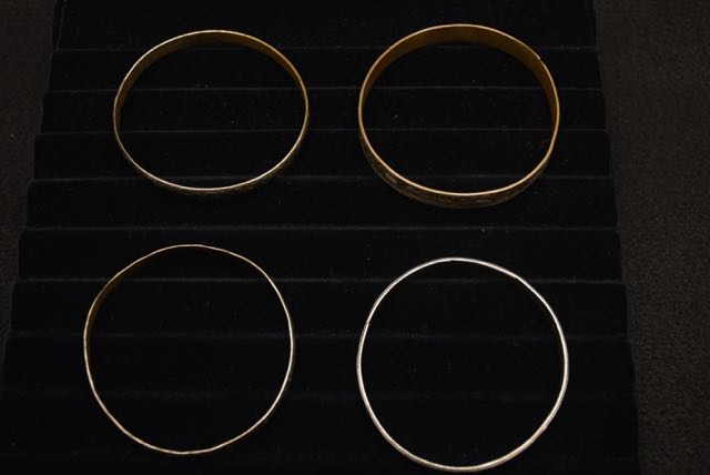 Four Ornate Bracelets Including one With an Egyptian Motif