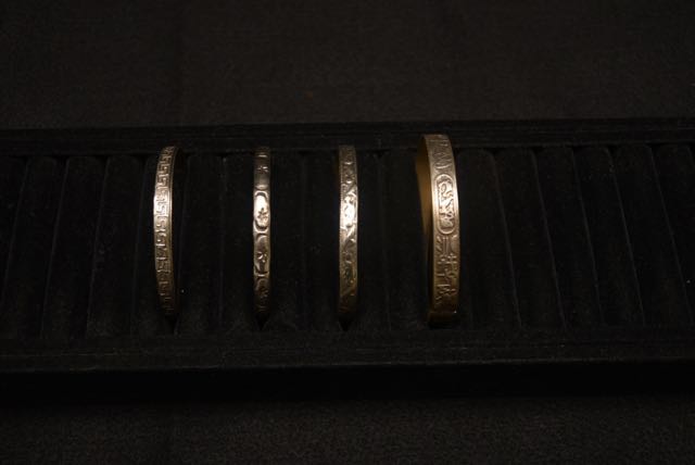 Four Ornate Bracelets Including one With an Egyptian Motif