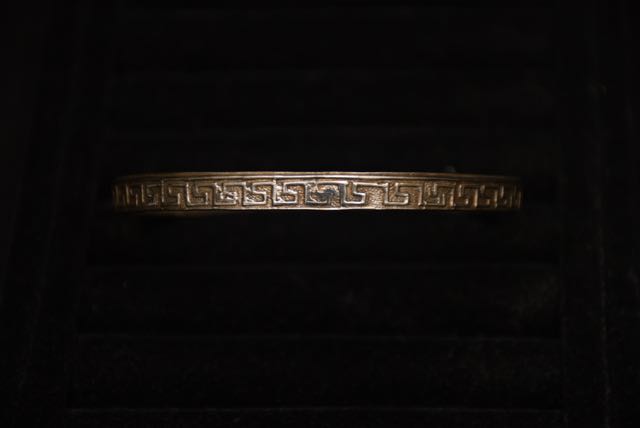 Four Ornate Bracelets Including one With an Egyptian Motif