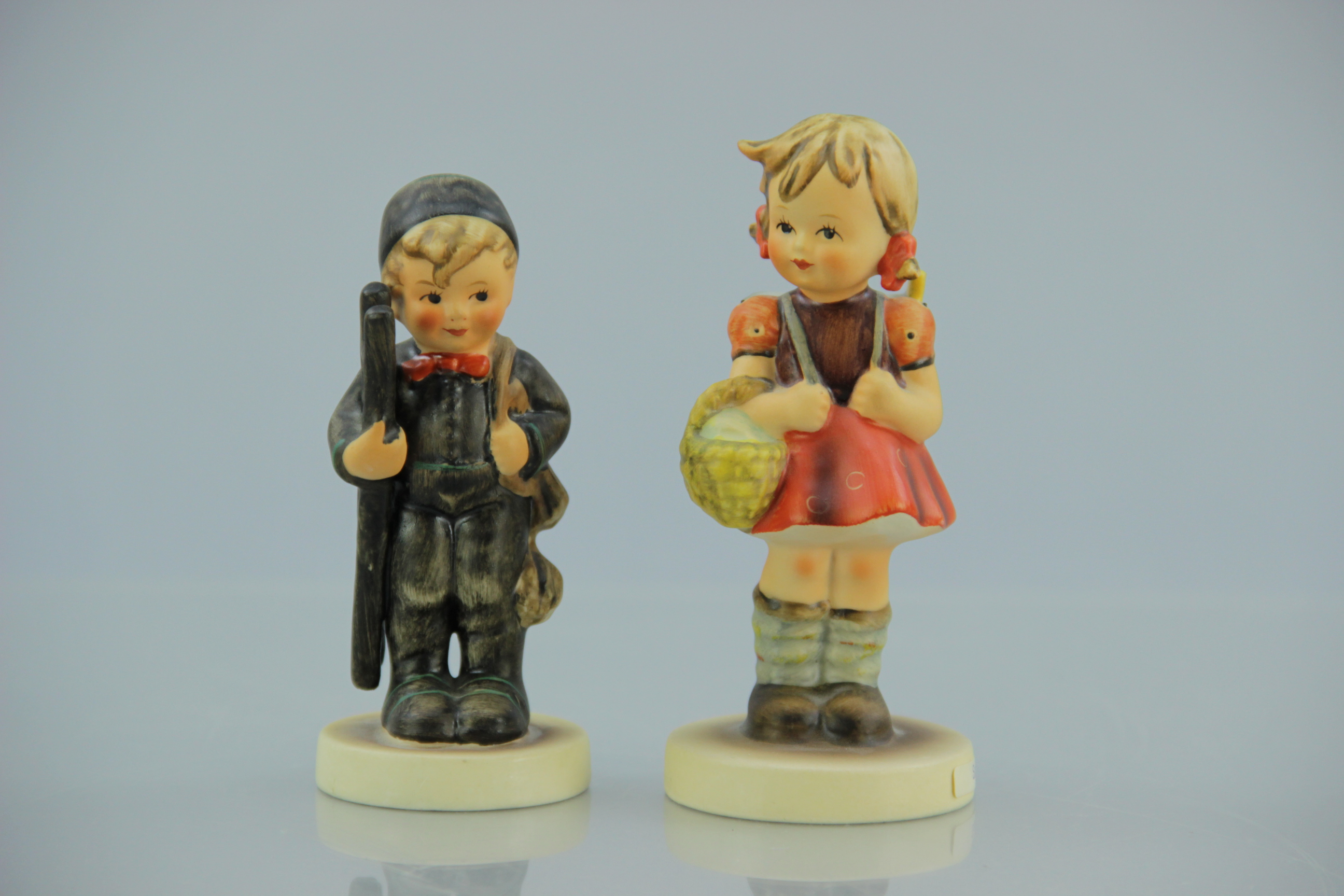 Porcelain M.I. Hummel Chimney Sweep and School Girl Figurines