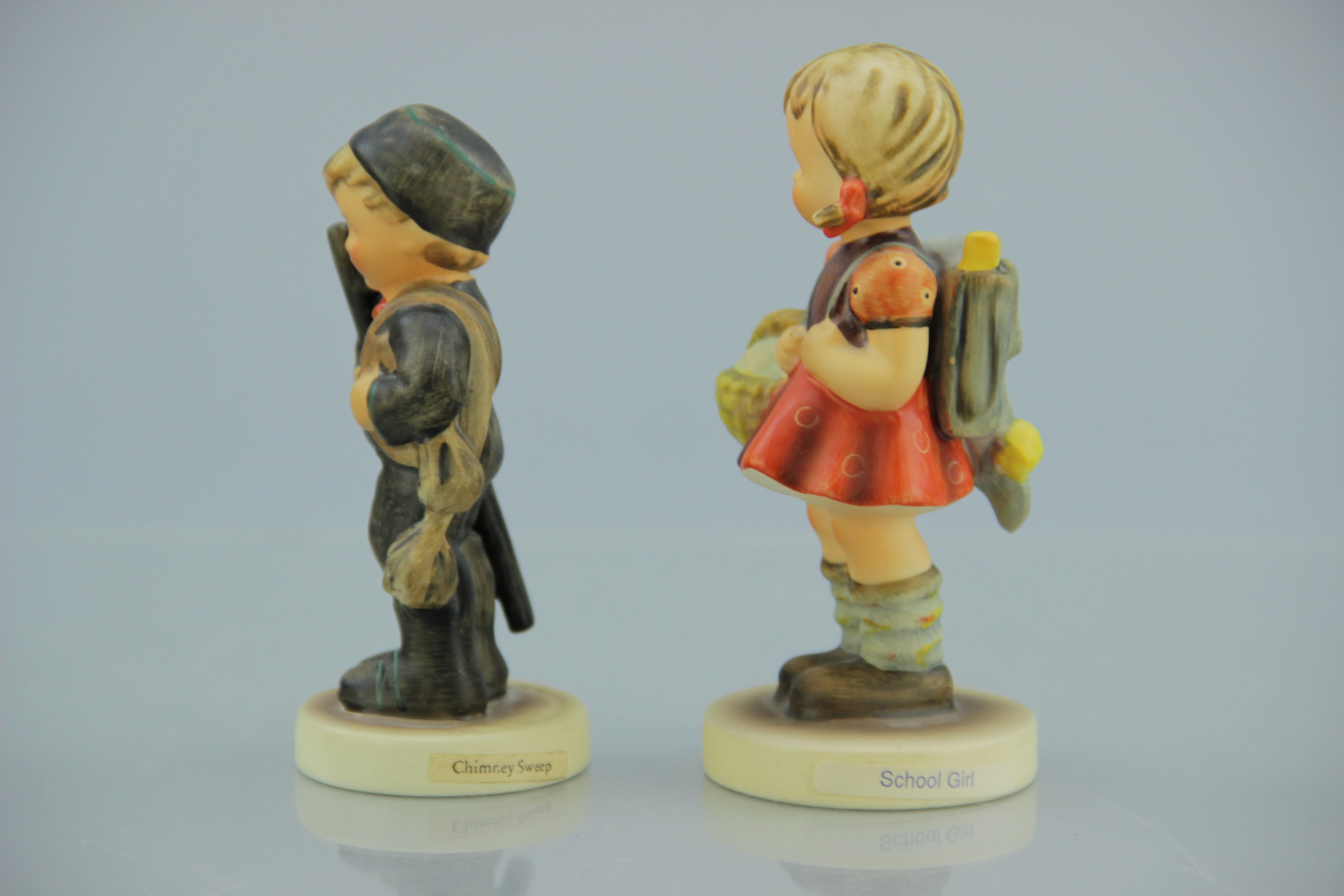 Porcelain M.I. Hummel Chimney Sweep and School Girl Figurines