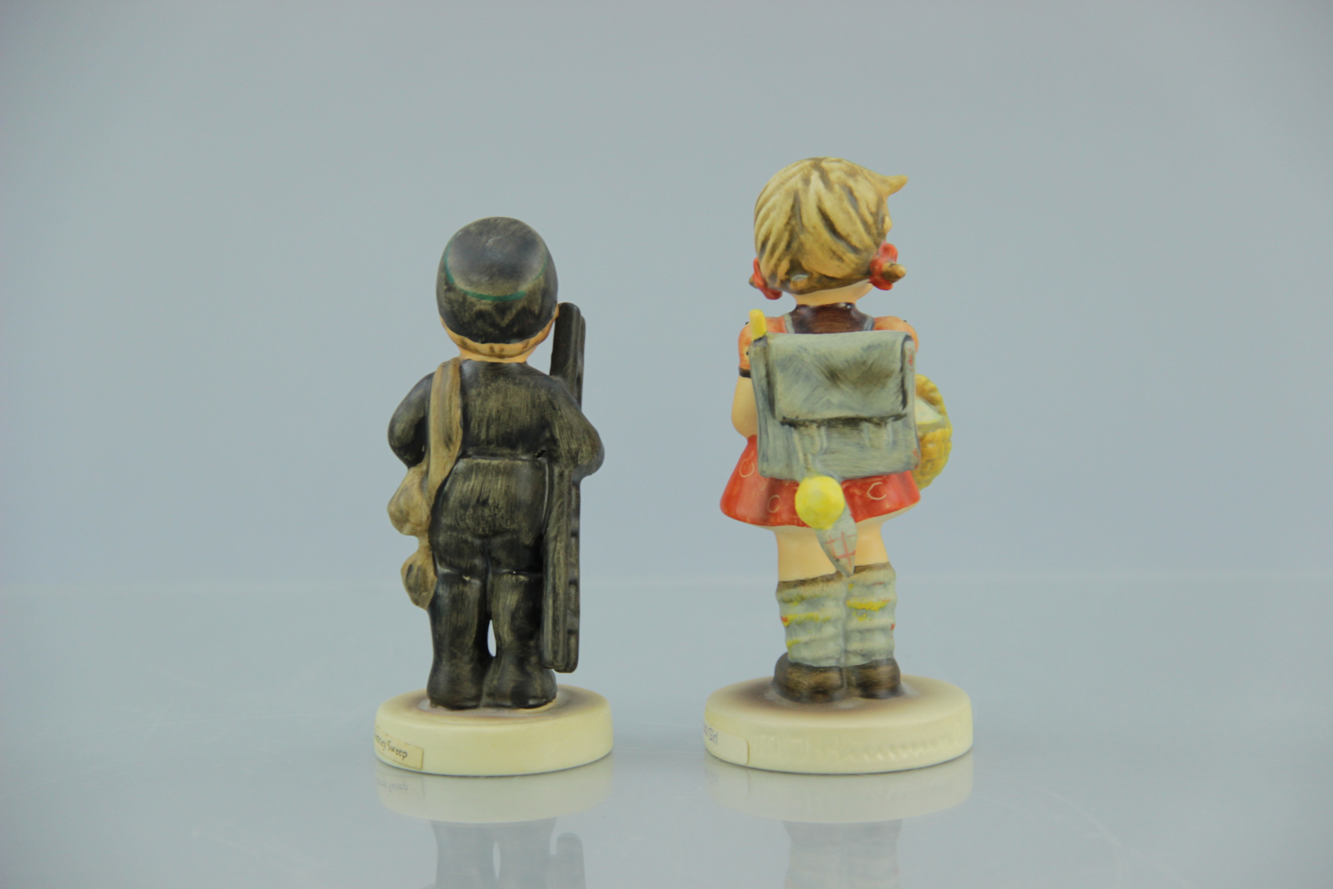 Porcelain M.I. Hummel Chimney Sweep and School Girl Figurines