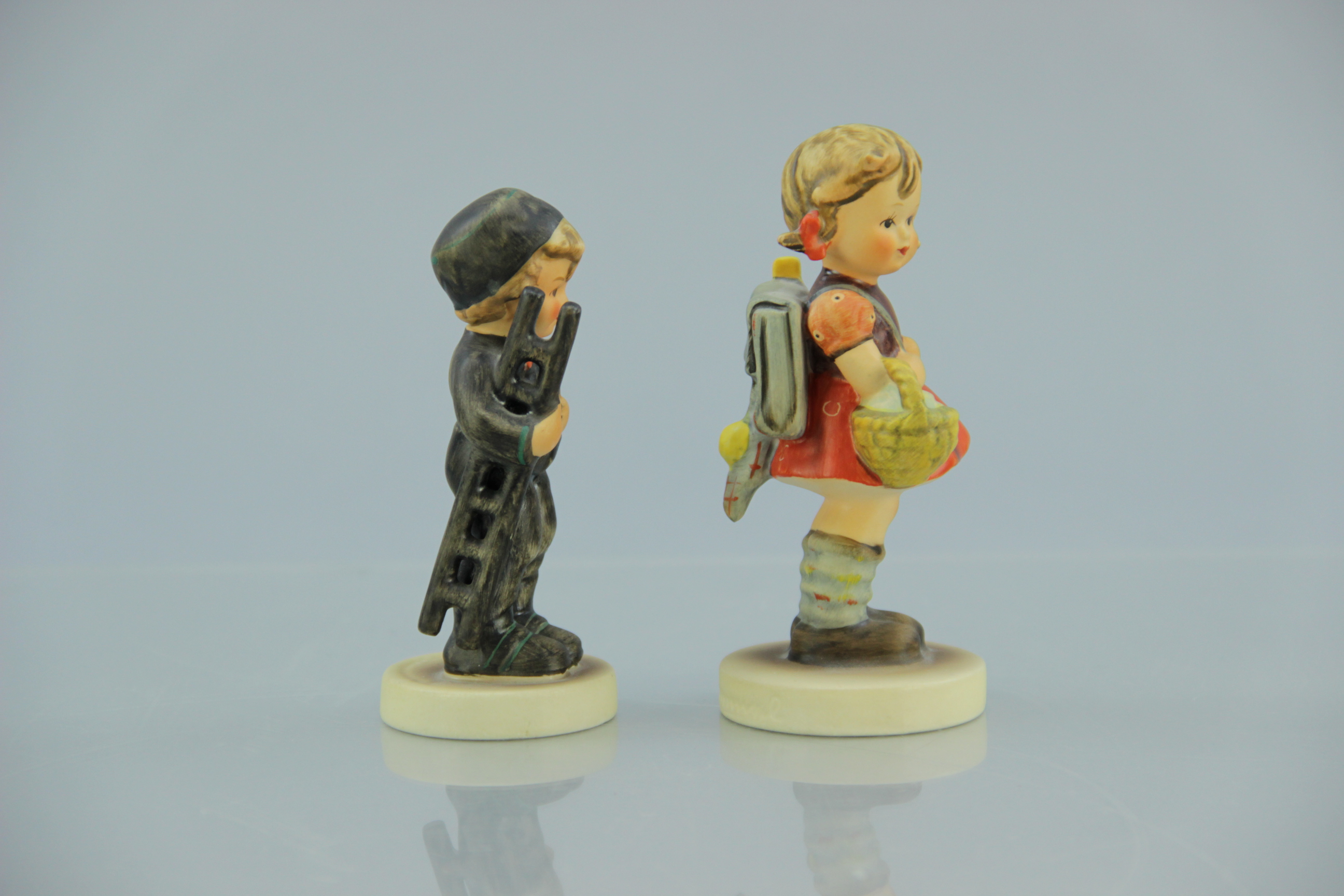 Porcelain M.I. Hummel Chimney Sweep and School Girl Figurines