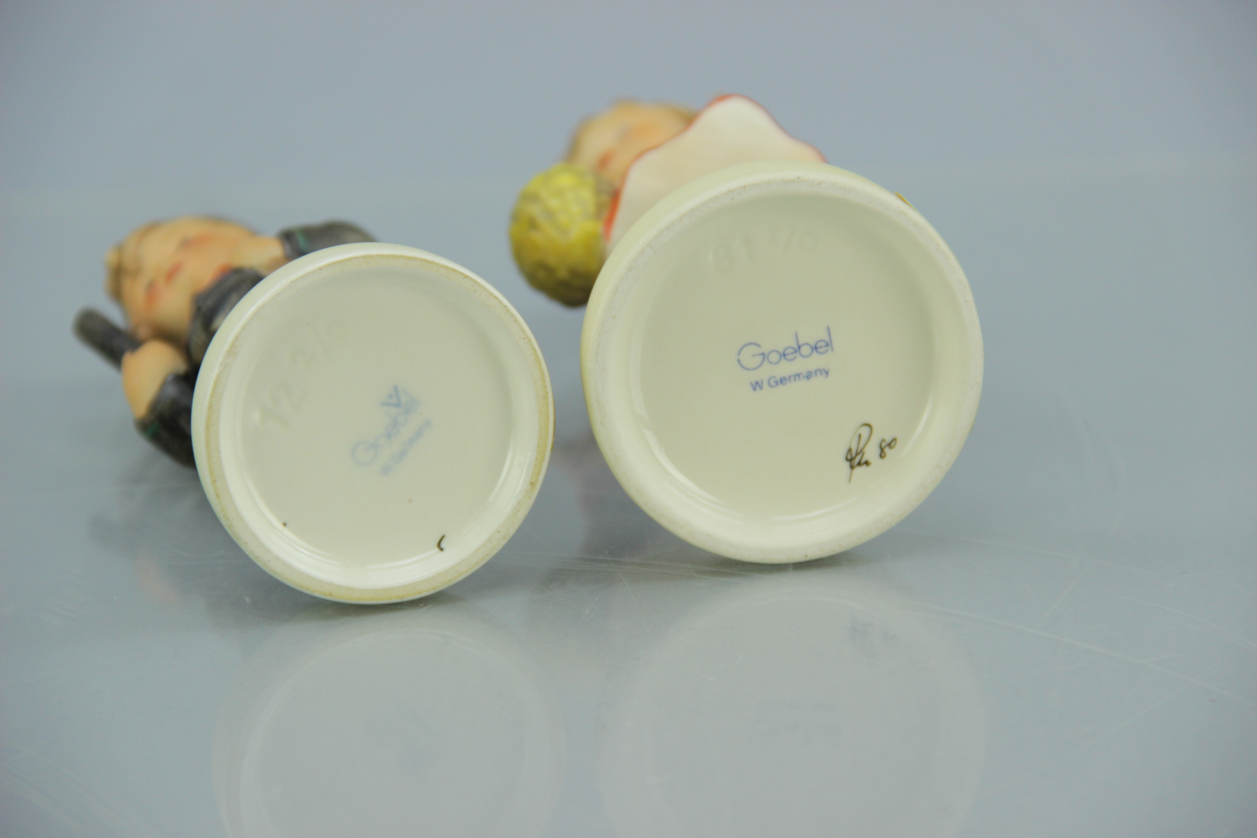 Porcelain M.I. Hummel Chimney Sweep and School Girl Figurines