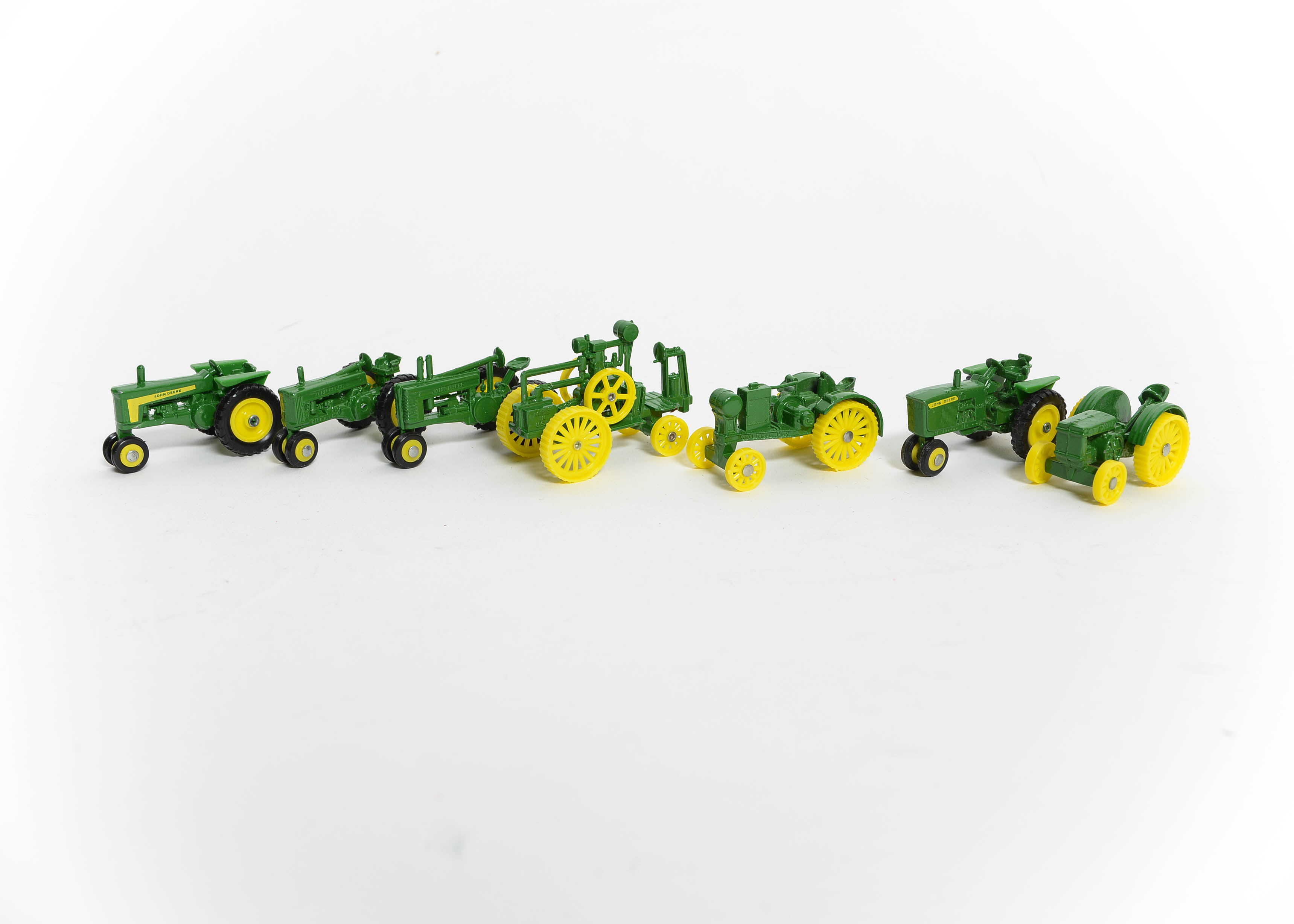 Seven John Deere Miniature Toy Tractors