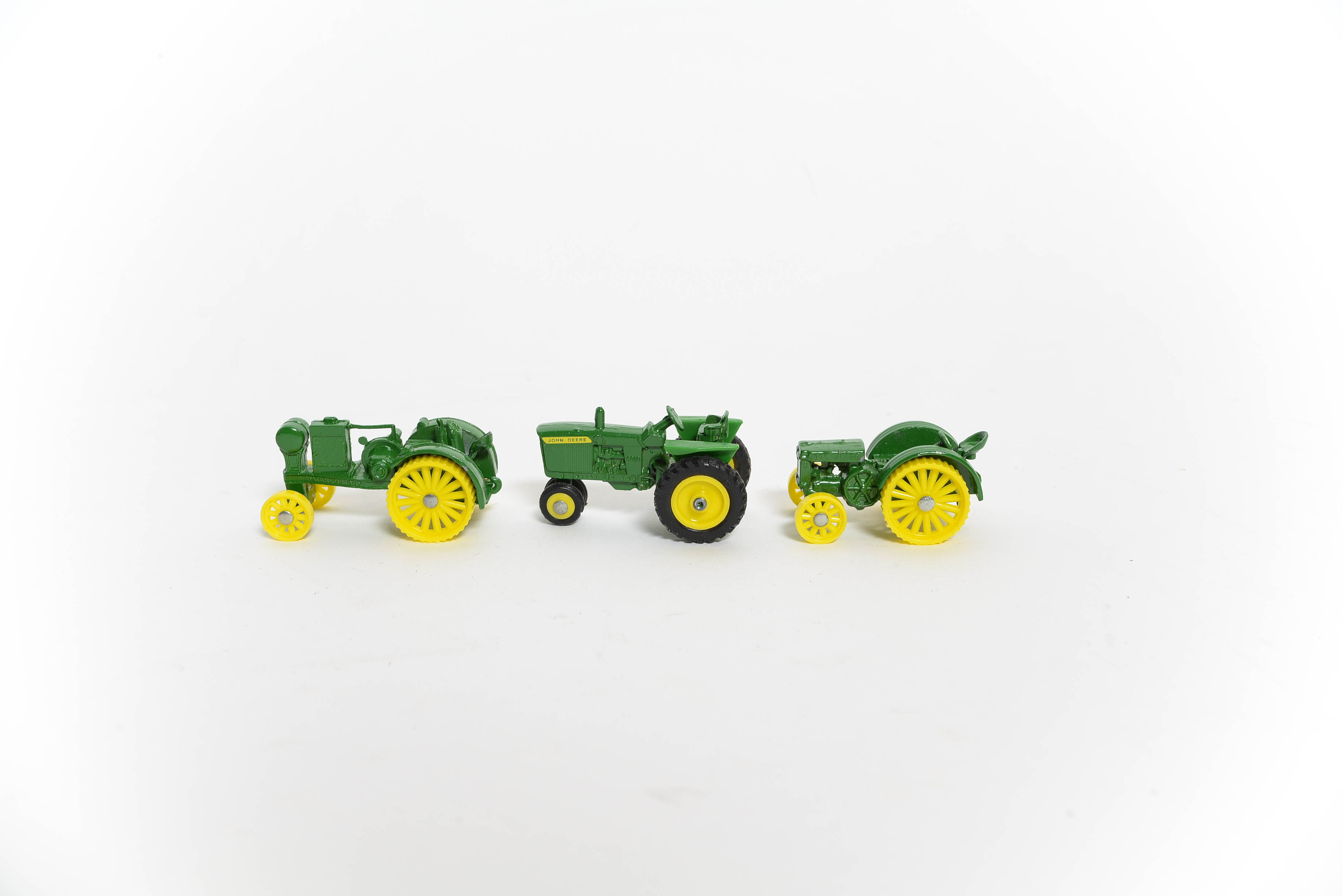 Seven John Deere Miniature Toy Tractors
