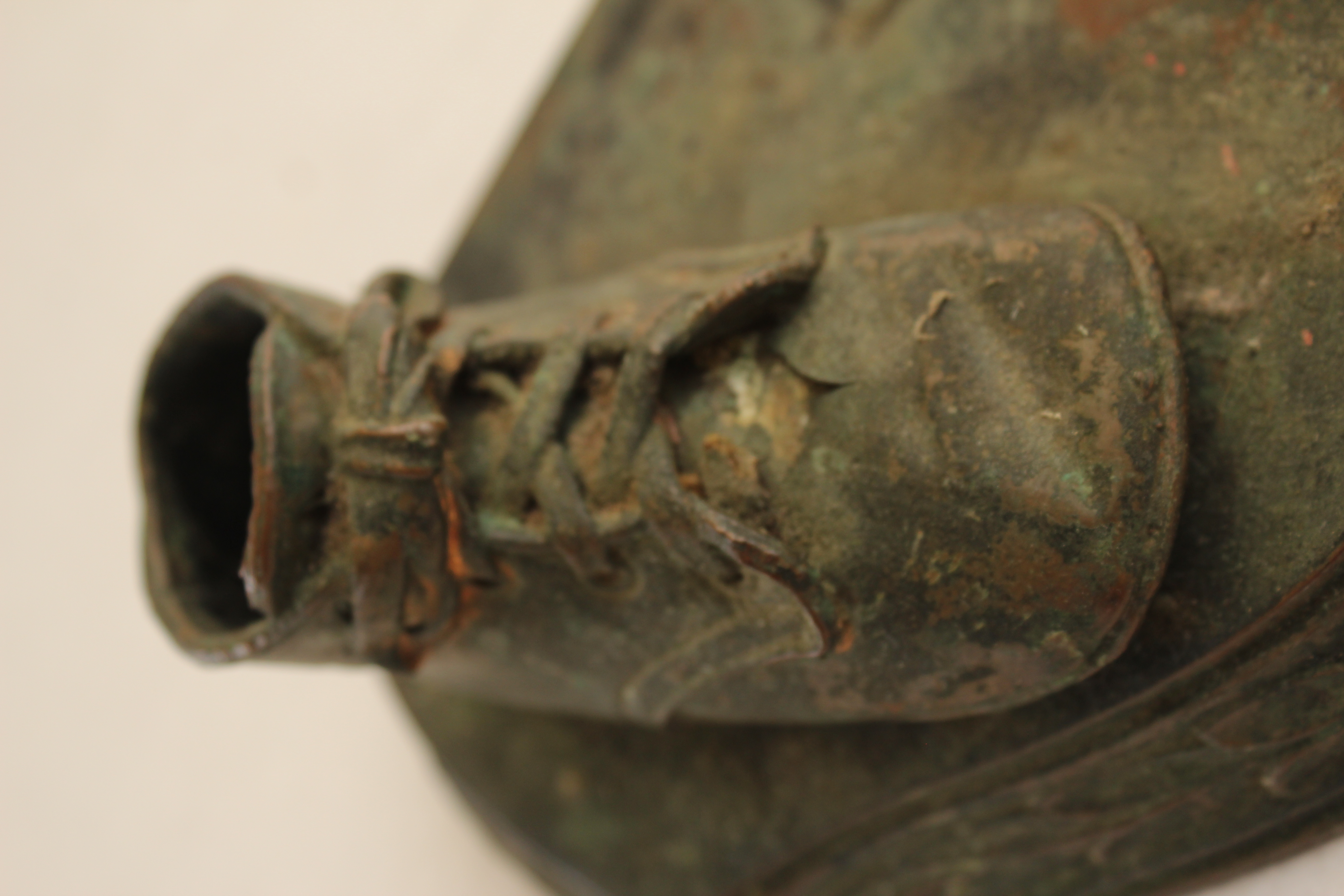 Pair of Vintage Distressed Bronze Look Baby Shoes on a Plinth