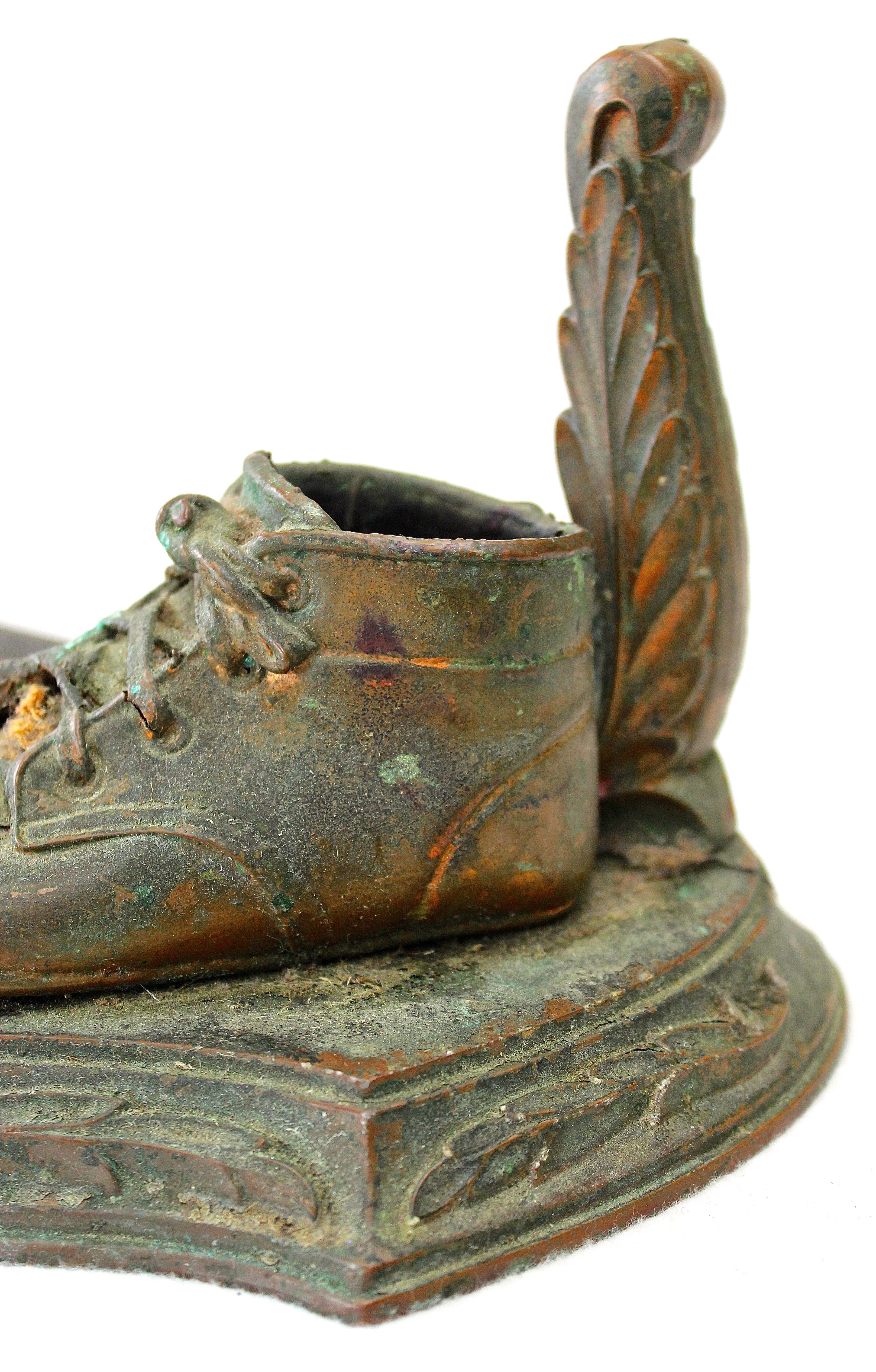 Pair of Vintage Distressed Bronze Look Baby Shoes on a Plinth