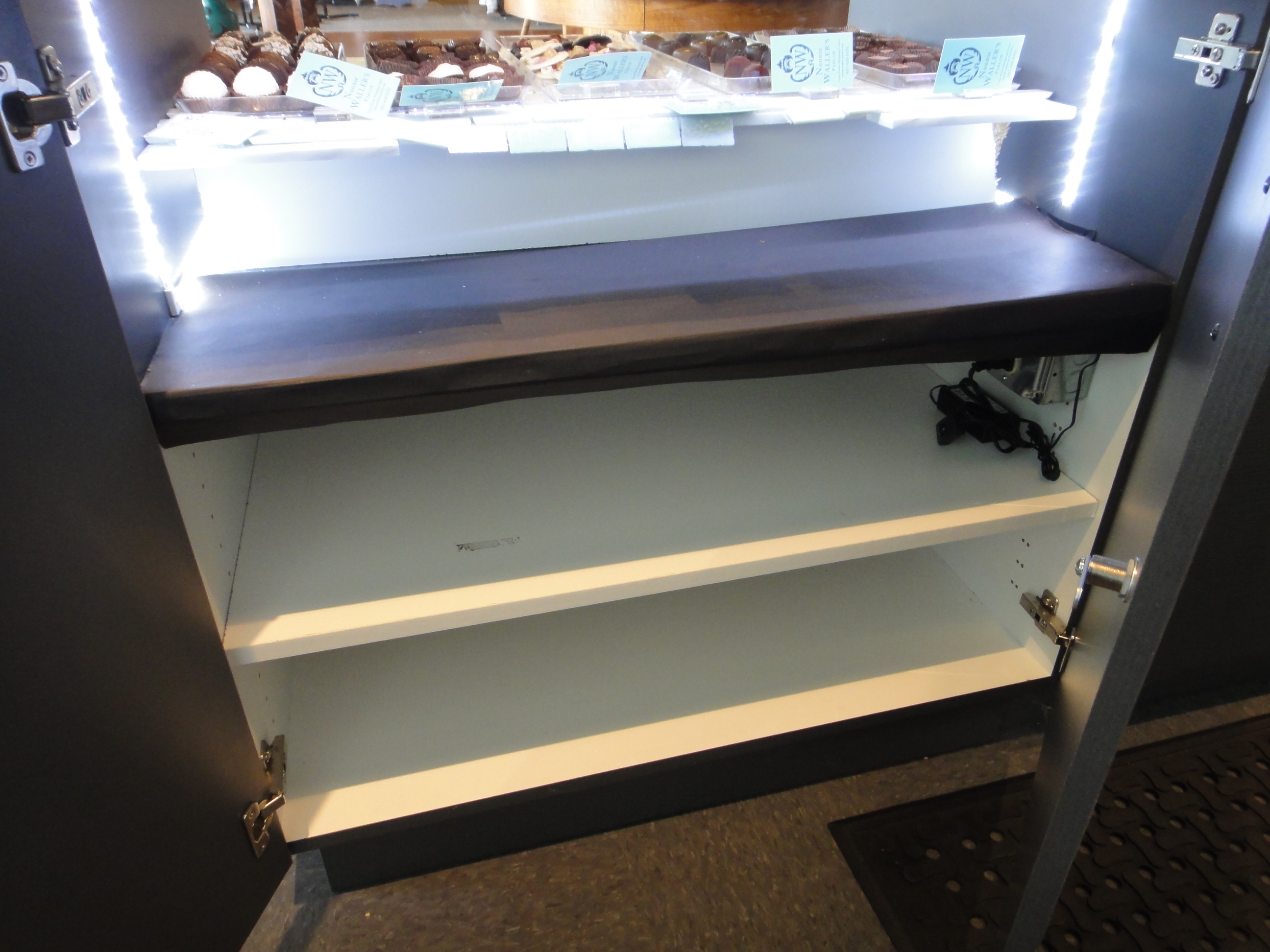 Custom Lighted Showcase by Thomas Cabinets Corian Ledge