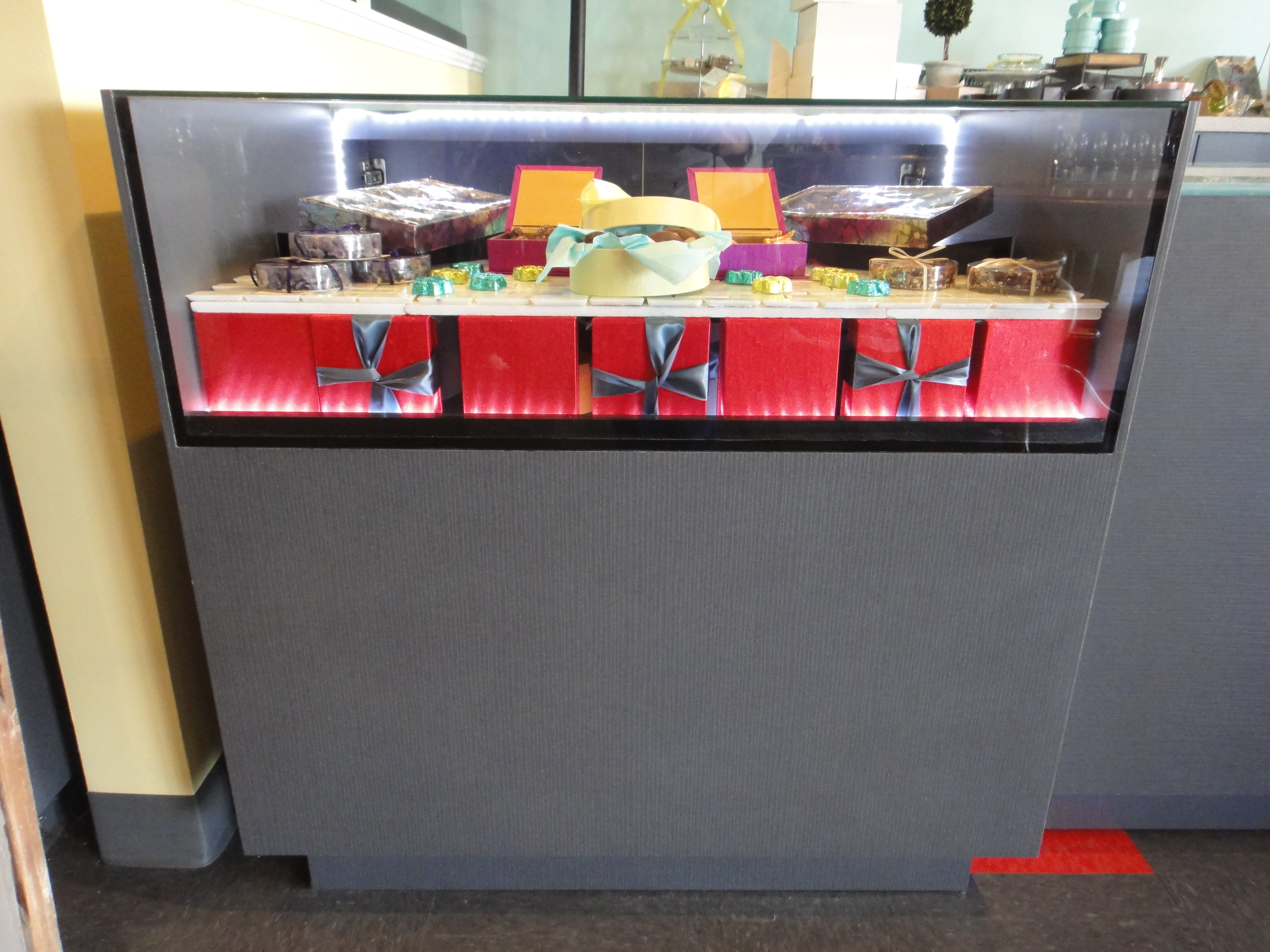 Custom Lighted Showcase by Thomas Cabinets Corian Ledge