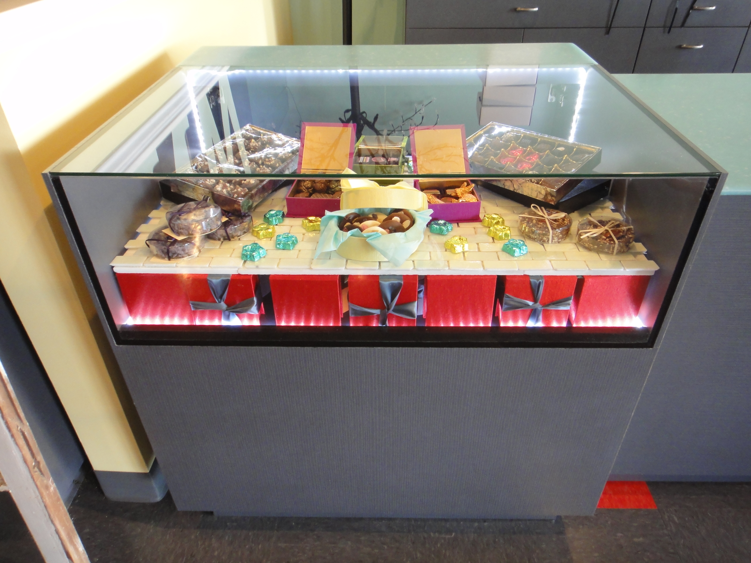 Custom Lighted Showcase by Thomas Cabinets Corian Ledge