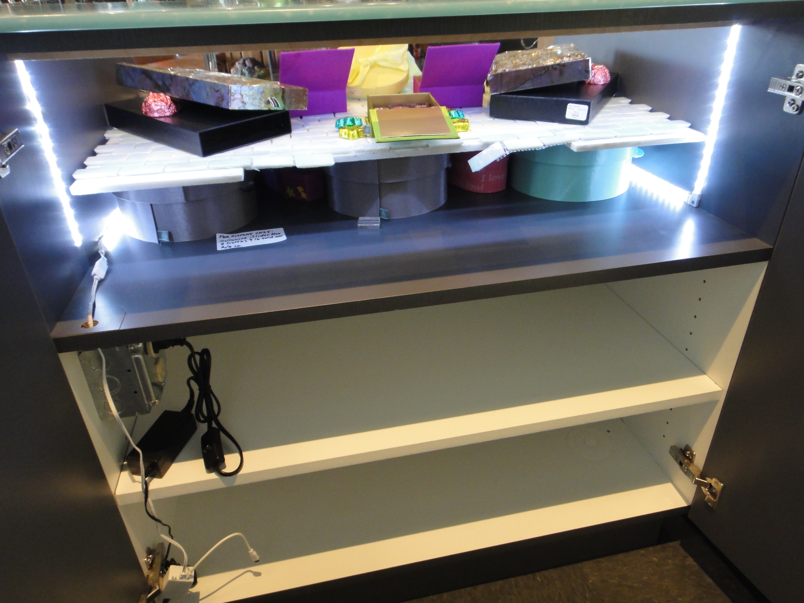 Custom Lighted Showcase by Thomas Cabinets Corian Ledge