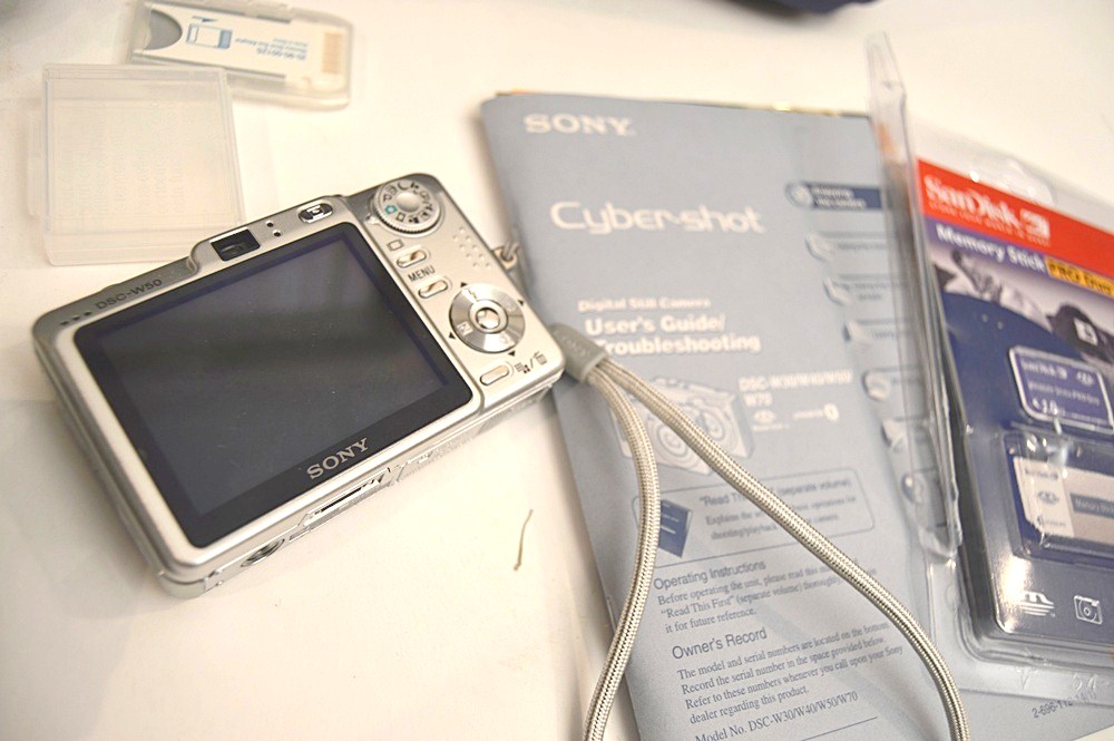 Sharper Image Computer Bag, Sony Cyper-Shot Camera, RCA Mini TV