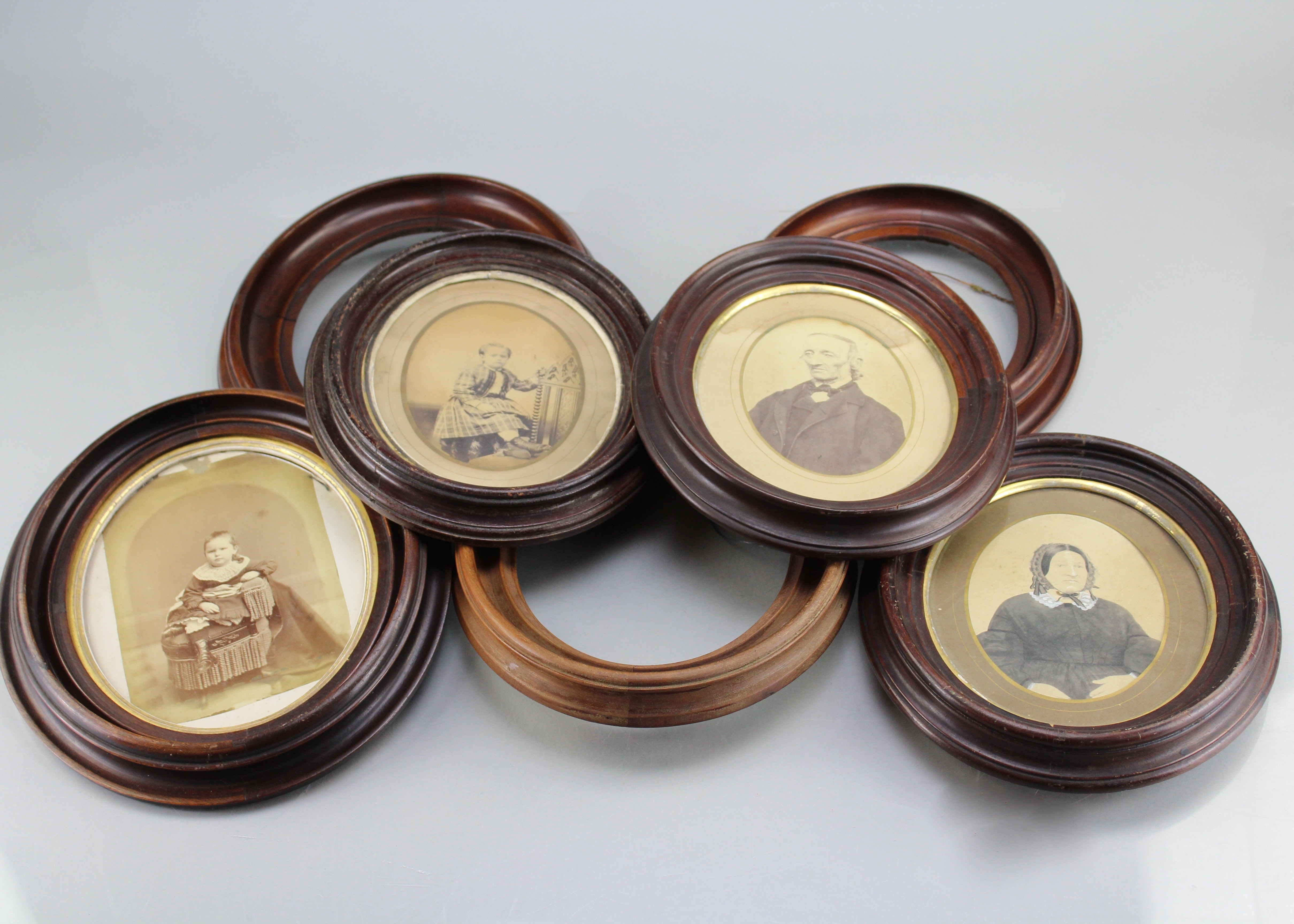Assortment of Oval Wooden Framed Portrait Photos and Empty Frames