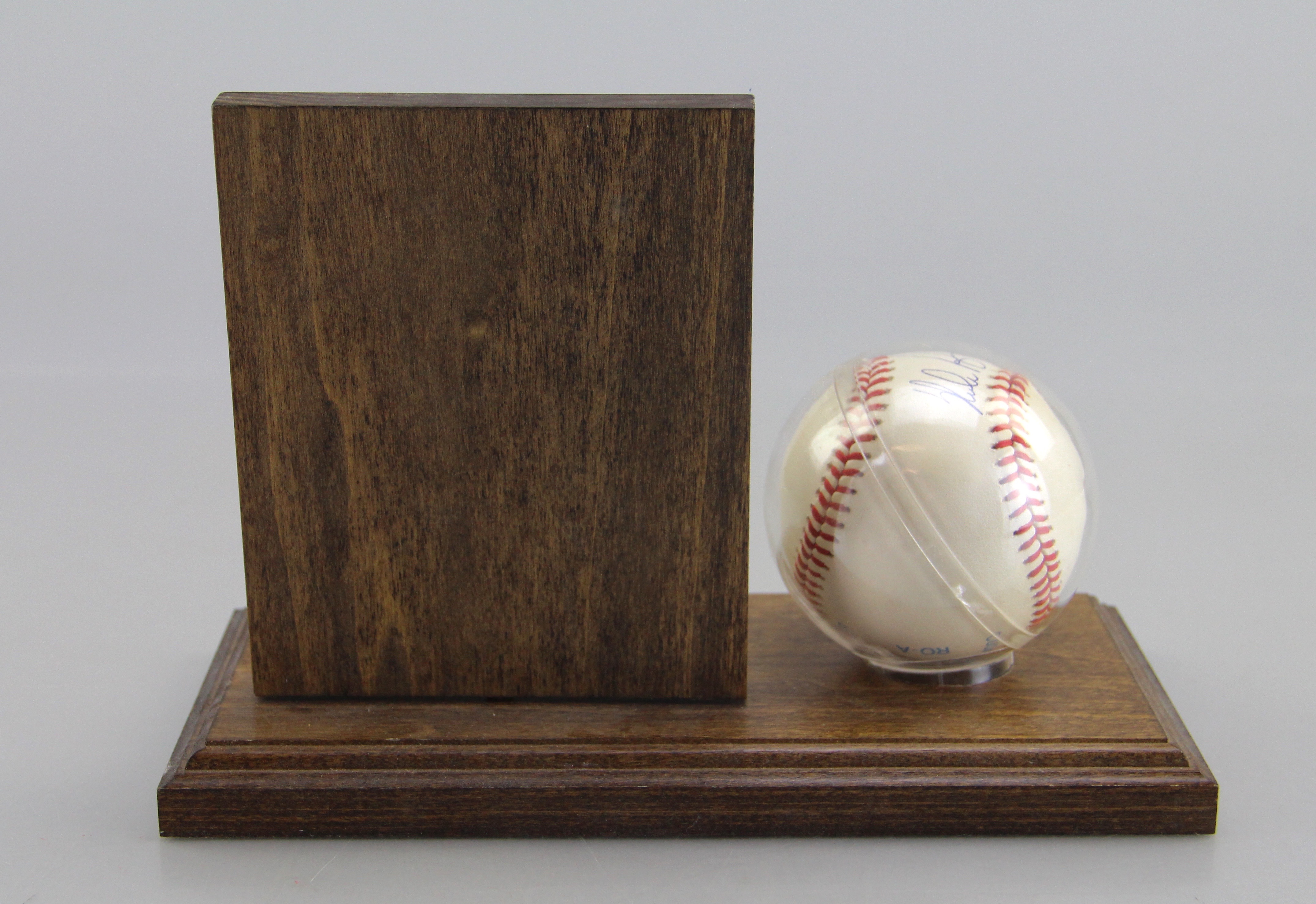 Autographed Nolan Ryan Baseball With Card On Wooden Stand