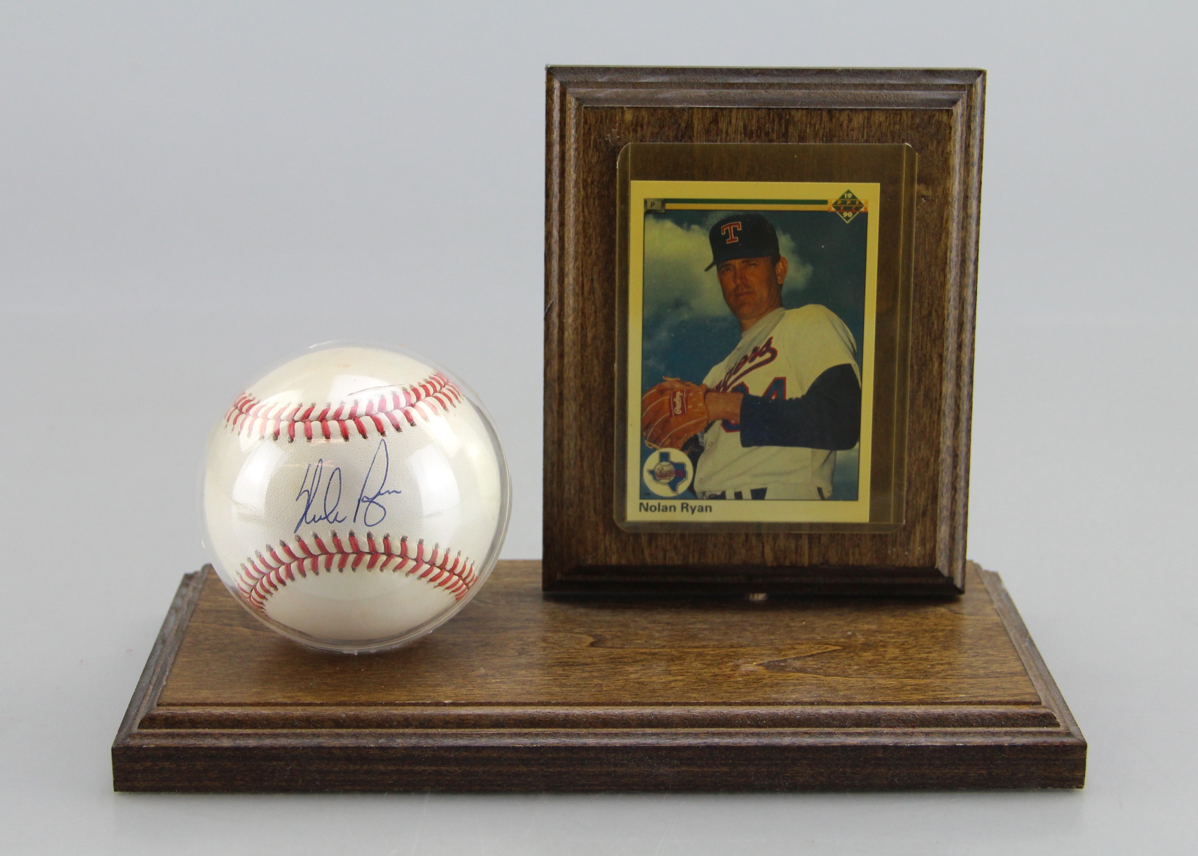 Autographed Nolan Ryan Baseball With Card On Wooden Stand